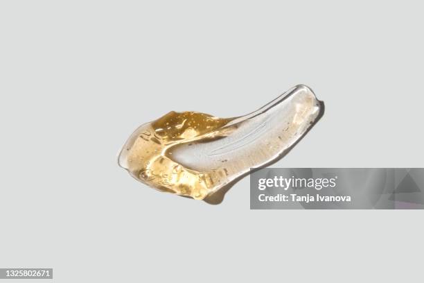 transparent smear of orange gel on white background. liquid yellow wax or sugar paste for depilation. the concept of depilation, waxing, sugaring smooth skin without hair, banner - shower gel stock pictures, royalty-free photos & images