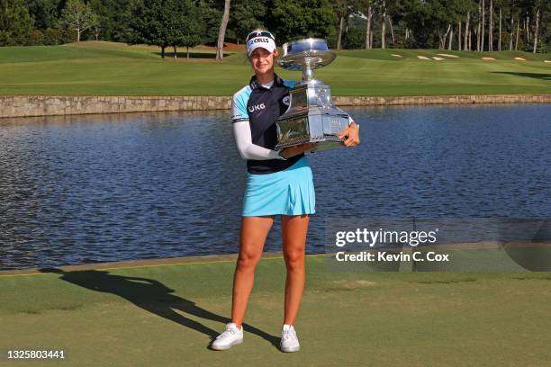 Nelly Korda poses with the trophy after putting in to win on the 18th green during the final round of the KPMG Women's PGA Championship at Atlanta...