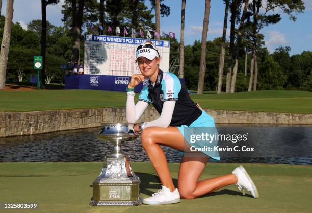 Nelly Korda poses with the trophy after putting in to win on the 18th green during the final round of the KPMG Women's PGA Championship at Atlanta...