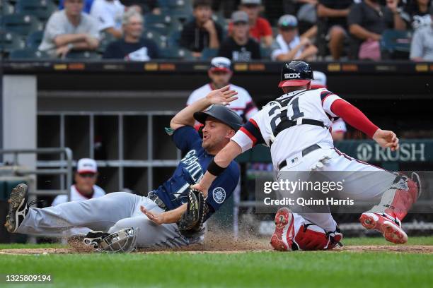 Kyle Seager of the Seattle Mariners is tagged out at home plate in the sixth inning against Zack Collins of the Chicago White Sox at Guaranteed Rate...