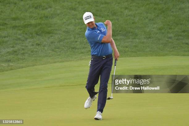 Harris English of the United States celebrates his birdie putt on the 18th green in the eighth playoff hole to win the Travelers Championship against...