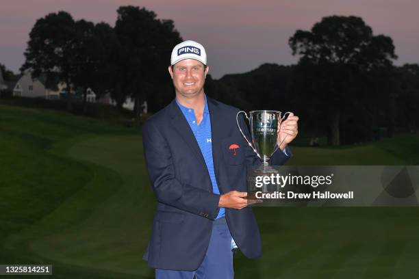 Harris English of the United States poses with the trophy after winning the Travelers Championship on the eighth playoff hole over Kramer Hickok of...