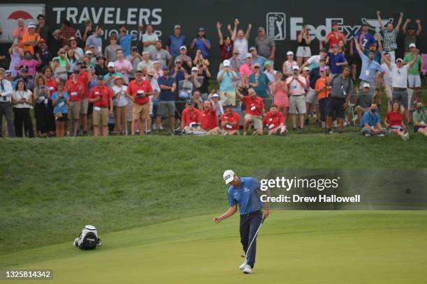 Harris English of the United States celebrates his birdie putt on the 18th green in the eighth playoff hole to win the Travelers Championship against...