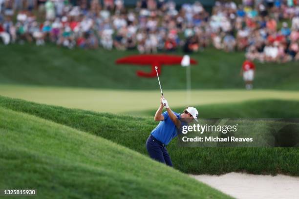 Harris English of the United States plays a shot from a bunker on the 18th hole in the fifth playoff hole against Kramer Hickok of the United States...