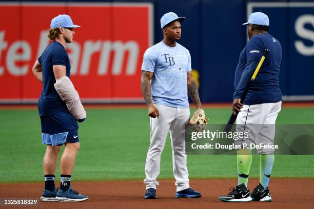 Taylor Walls and Wander Franco and third base coach Rodney Linares of the Tampa Bay Rays warm up prior to the game against the Los Angeles Angels at...