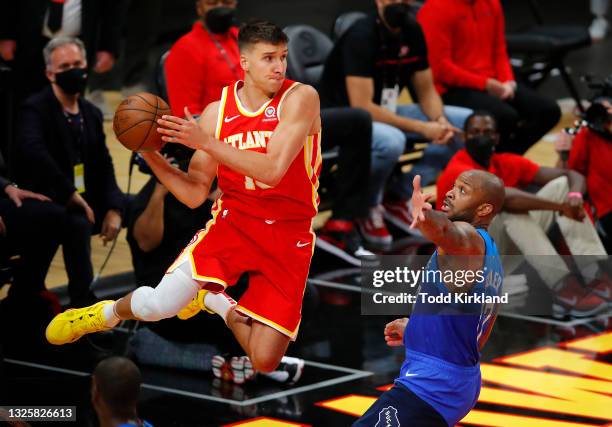 Bogdan Bogdanovic of the Atlanta Hawks makes a save against P.J. Tucker of the Milwaukee Bucks during the second half in game three of the Eastern...