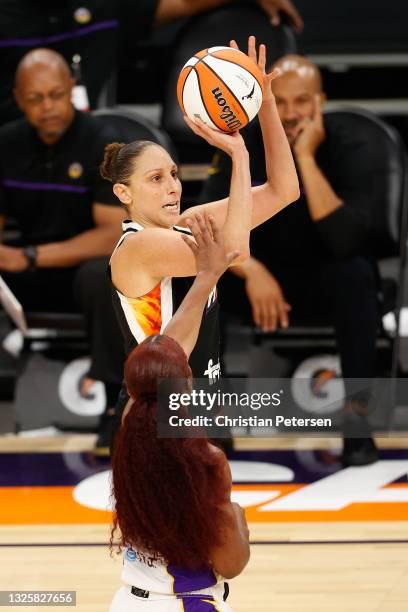 Diana Taurasi of the Phoenix Mercury attempts a three-point shot against the Los Angeles Sparks during the second half of the WNBA game at Phoenix...