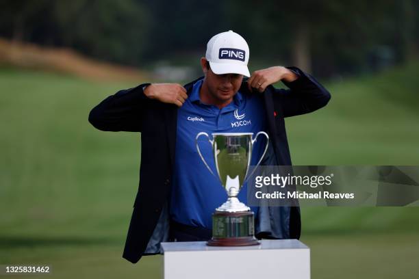 Harris English of the United States is presented with the winner's jacket after winning the Travelers Championship in the eighth playoff hole against...