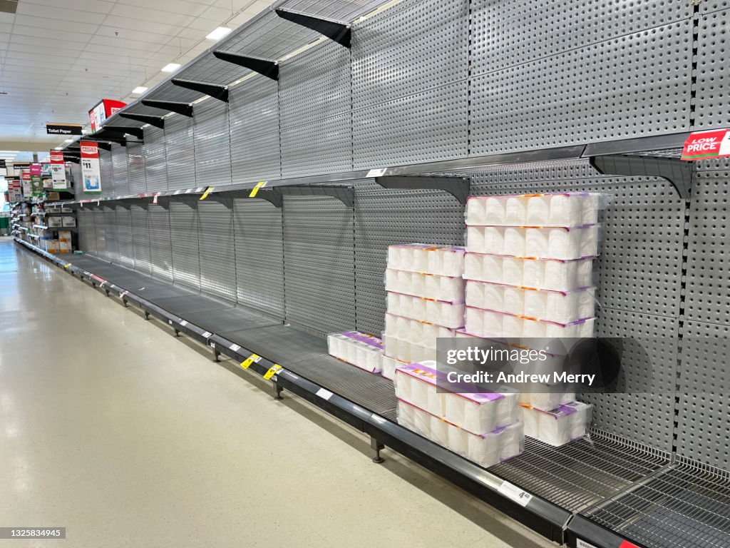 Toilet paper on empty supermarket shelves, lockdown panic buying