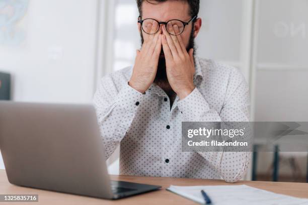 tired businessman - rubbing eyes stock pictures, royalty-free photos & images
