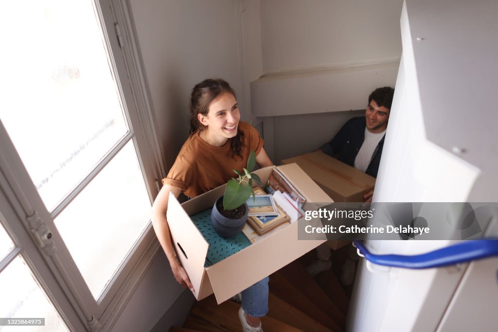 A happy young couple moving into a new apartment