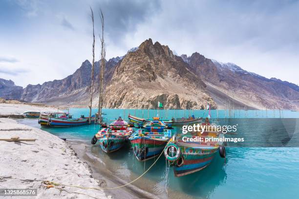 lac panoramique attabad, bateau traditionnel vif et haute montagne à gojal, vallée de hunza au pakistan. - gilgit baltistan photos et images de collection