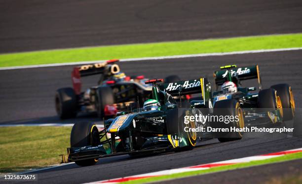 Finnish Team Lotus Formula One driver Heikki Kovalainen driving his T128 racing car ahead of his Italian teammate Jarno Trulli and Lotus Renault...