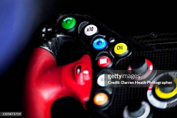 Scuderia Toro Rosso Formula One steering wheel from the Italian team's STR6 racing cars showing colourful mode selection buttons and dials at the...