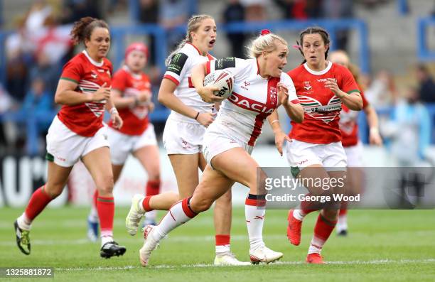 Amy Hardcastle of England breaks away during the Rugby League International match between England Women and Wales Women at The Halliwell Jones...