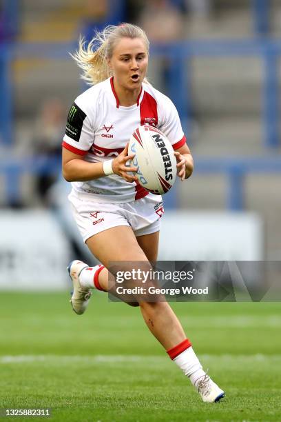 Tara Stanley of England runs with the ball during the Rugby League International match between England Women and Wales Women at The Halliwell Jones...