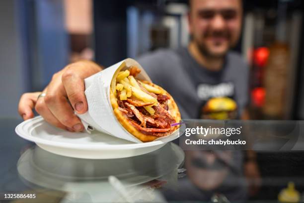 chef serving finished gyros - kebab stock pictures, royalty-free photos & images