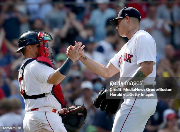 Boston Red Sox relief pitcher Yacksel Rios celebrates the win with Christian Vazquez during the 9th inning of the game against the New York Yankees...