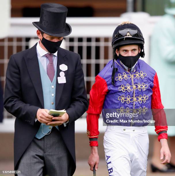 Trainer Andrew Balding and jockey Ryan Moore in the parade ring before riding Queen Elizabeth II's horse 'King's Lynn' in the Wokingham Stakes on day...