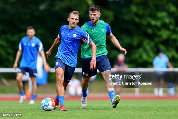 Eduard Loewen challenges Robert Tesche during the start of VfL Bochum training at training ground on June 28, 2021 in Bochum, Germany.