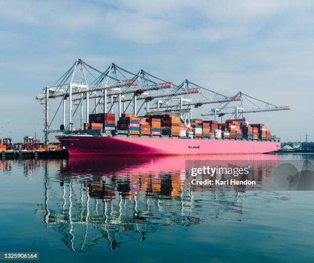 a daytime view of a container ship being loaded in port, uk - stock photo - solent stock pictures, royalty-free photos & images