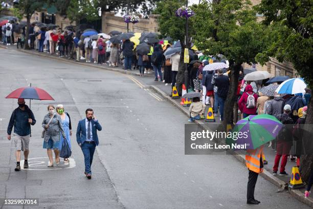 Tennis fans queue to enter the Wimbledon All England Tennis Club ahead of day one of the Wimbledon tennis championships on June 27, 2021 in...