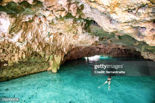 woman swimming in cenote cancun - mayan riviera stock pictures, royalty-free photos & images