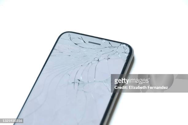 mobile phone with broken screen against white background - cracked iphone stock pictures, royalty-free photos & images