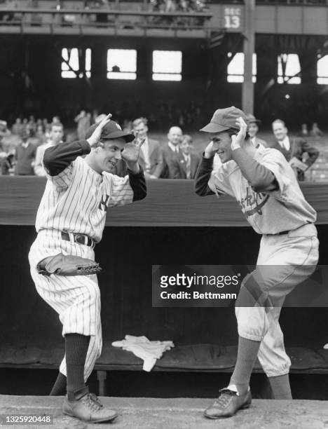 Batboys Tim Sullivan of the New York Yankees and Jackie Bodner of the Brooklyn Dodgers heckle each other before the start of the first game of the...