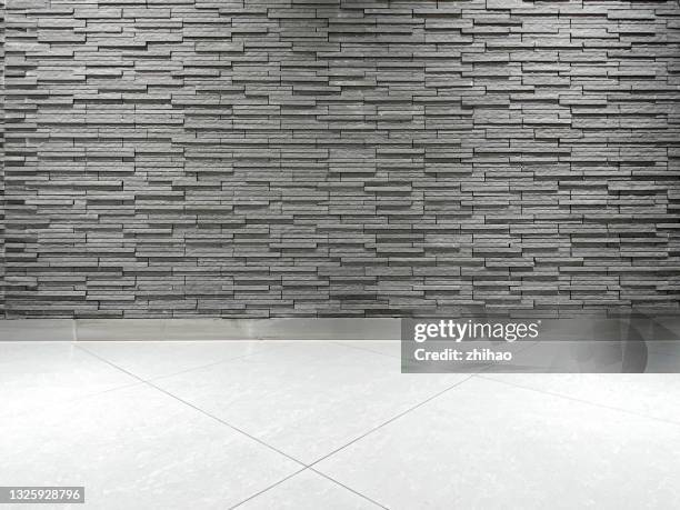 rock wall and empty tile floor - slate rock stock-fotos und bilder