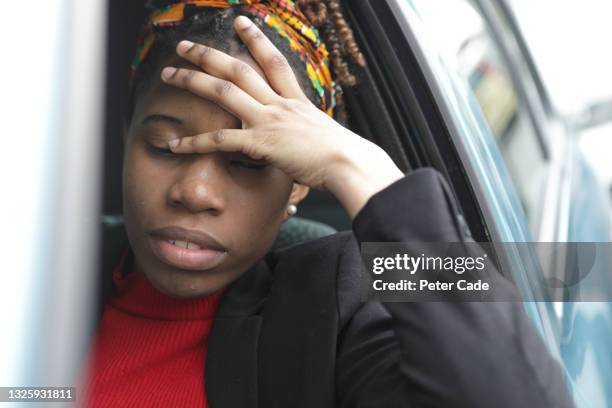 young woman in car looking stressed - crashes plymouth stock pictures, royalty-free photos & images