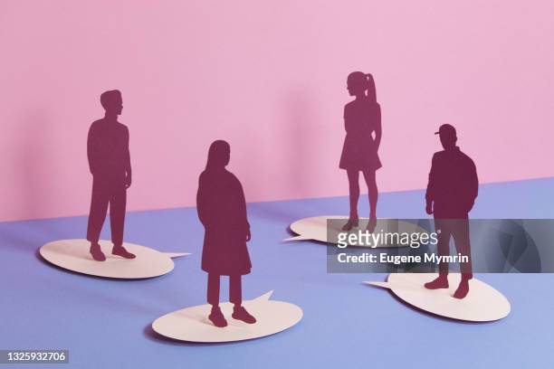 group of people standing on speech bubbles - papercutting stock-fotos und bilder