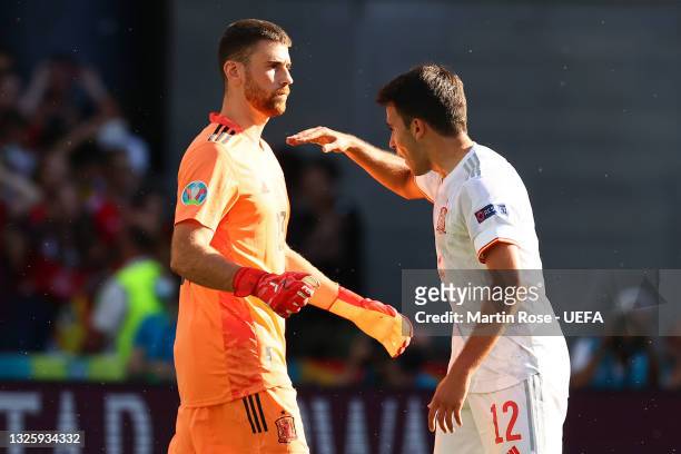 Unai Simon of Spain looks dejected as he is encouraged by teammate Eric Garcia after scoring an own goal for the Croatia first goal during the UEFA...