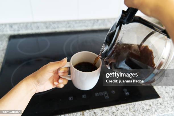 first person view of a woman pouring a fresh cup of coffee, pov - personal perspective coffee stock pictures, royalty-free photos & images