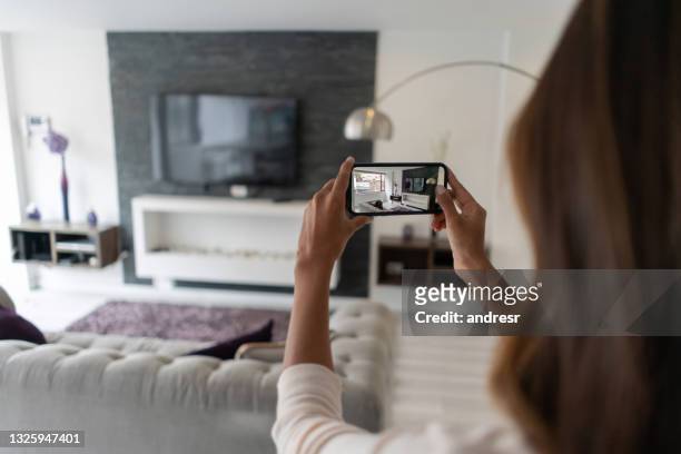 real estate agent making a virtual tour of a house using her cell phone - house viewing stock pictures, royalty-free photos & images