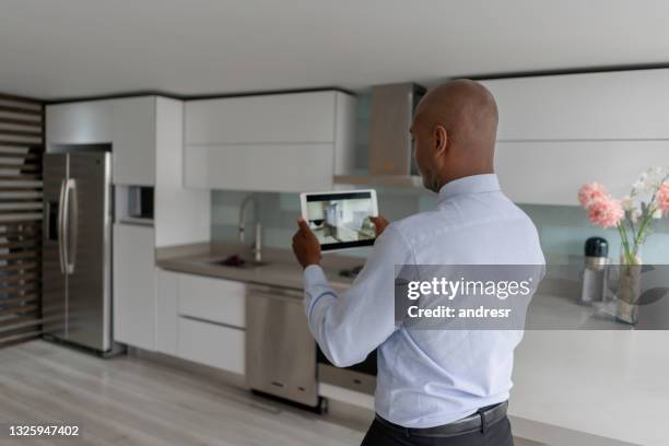 real estate agent making a virtual tour of a house using a tablet computer - virtual visit stock pictures, royalty-free photos & images