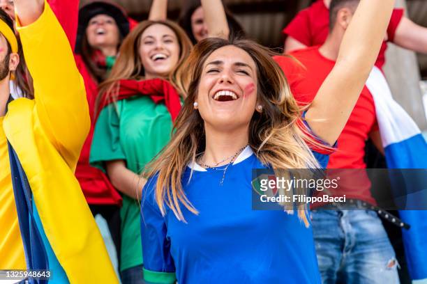 multi colored fans at stadium are supporting their team - awards party 2018 stock pictures, royalty-free photos & images