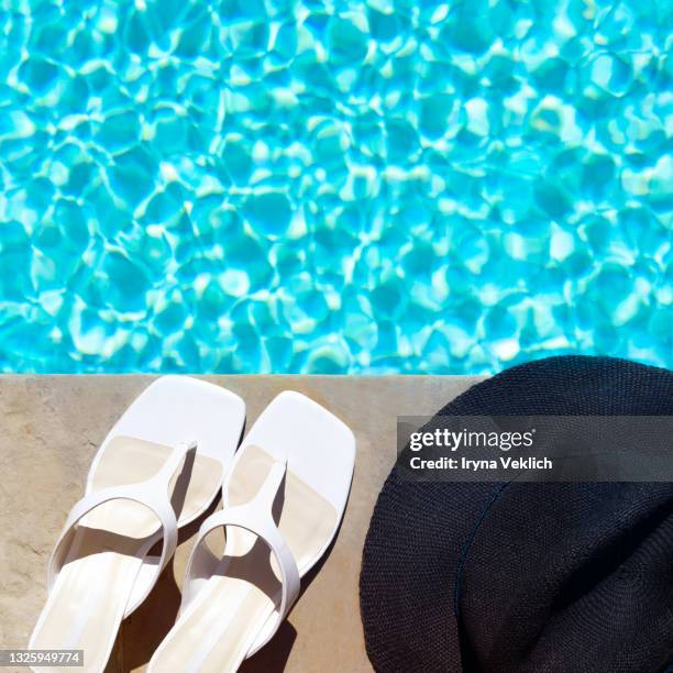 swimming pool with turquoise water, fashion white shoes and straw hat as sunny summer background. - blue white summer hat background stock pictures, royalty-free photos & images