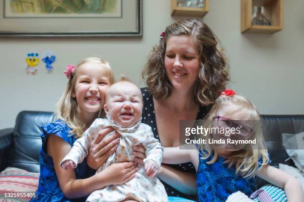 mother with three daughter - crying sibling stock pictures, royalty-free photos & images