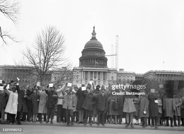 Group of Black students from Howard University pray near the Capitol grounds today for passage of the civil rights legislation now pending before the...