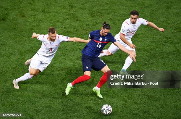 Adrien Rabiot of France is closed down by Silvan Widmer and Xherdan Shaqiri of Switzerland during the UEFA Euro 2020 Championship Round of 16 match...