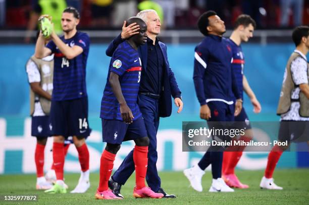 Didier Deschamps, Head Coach of France consoles N'Golo Kante of France after losing in the penalty shoot out in the UEFA Euro 2020 Championship Round...