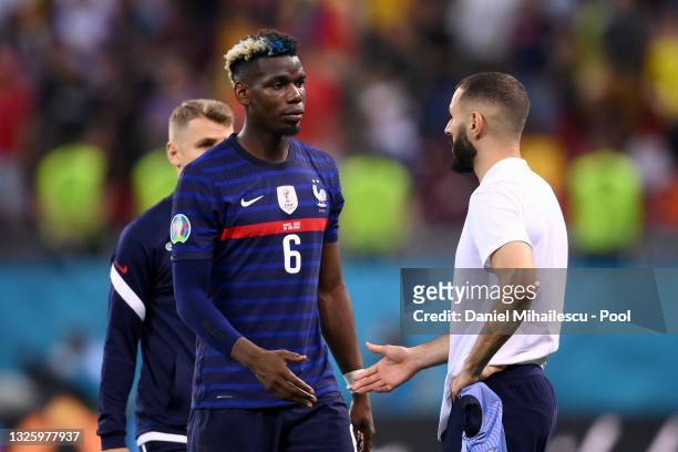Paul Pogba of France looks dejected as he interacts with team mate Karim Benzema after the UEFA Euro 2020 Championship Round of 16 match between...