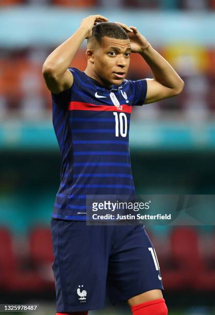 Kylian Mbappe of France looks dejected after having their side's decisive penalty saved by Yann Sommer of Switzerland in the penalty shoot out after...
