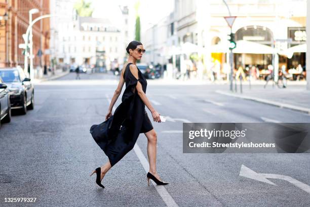 Model and artist Zoe Helali wearing a black dress dress by Sasha, black vintage pumps and sunglasses by Lunette Selection Berlin during a street...