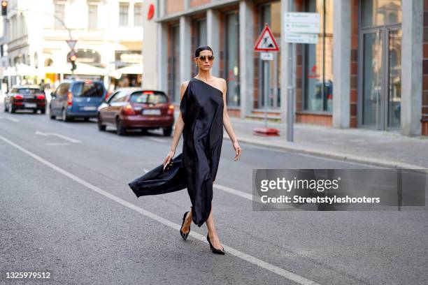 Model and artist Zoe Helali wearing a black dress dress by Sasha, black vintage pumps and sunglasses by Lunette Selection Berlin during a street...