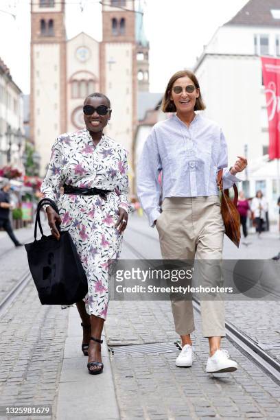 Auma Obama wearing a cream colored midi length longsleeve dress with all over multicolor floral print and ruffle details by Isabel Marant Etoile, a...