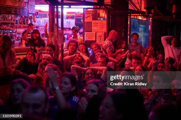 French football fans watch their team nervously in a Paris bar, as France are knocked out of the European Championships on penalties by Switzerland...