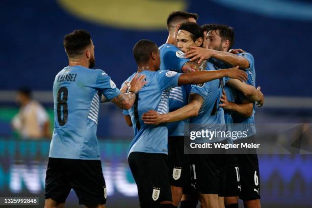 Edinson Cavani of Uruguay celebrates with teammates after scoring the first goal of his team during a group A match between Uruguay and Paraguay as...