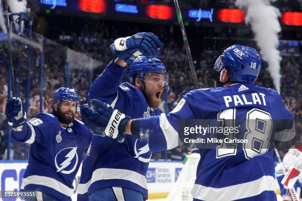 Erik Cernak of the Tampa Bay Lightning is congratulated by Ondrej Palat and Nikita Kucherov after scoring a goal against the Montreal Canadiens...